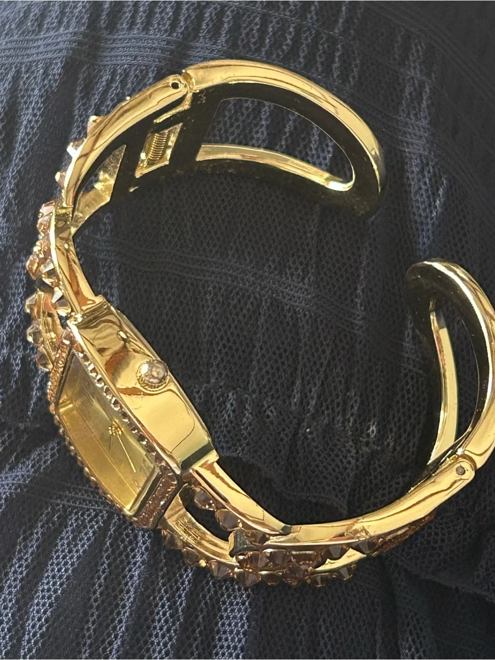 Jimmy Crystal elegant gold tone cuff watch with sparkling crystal accents.